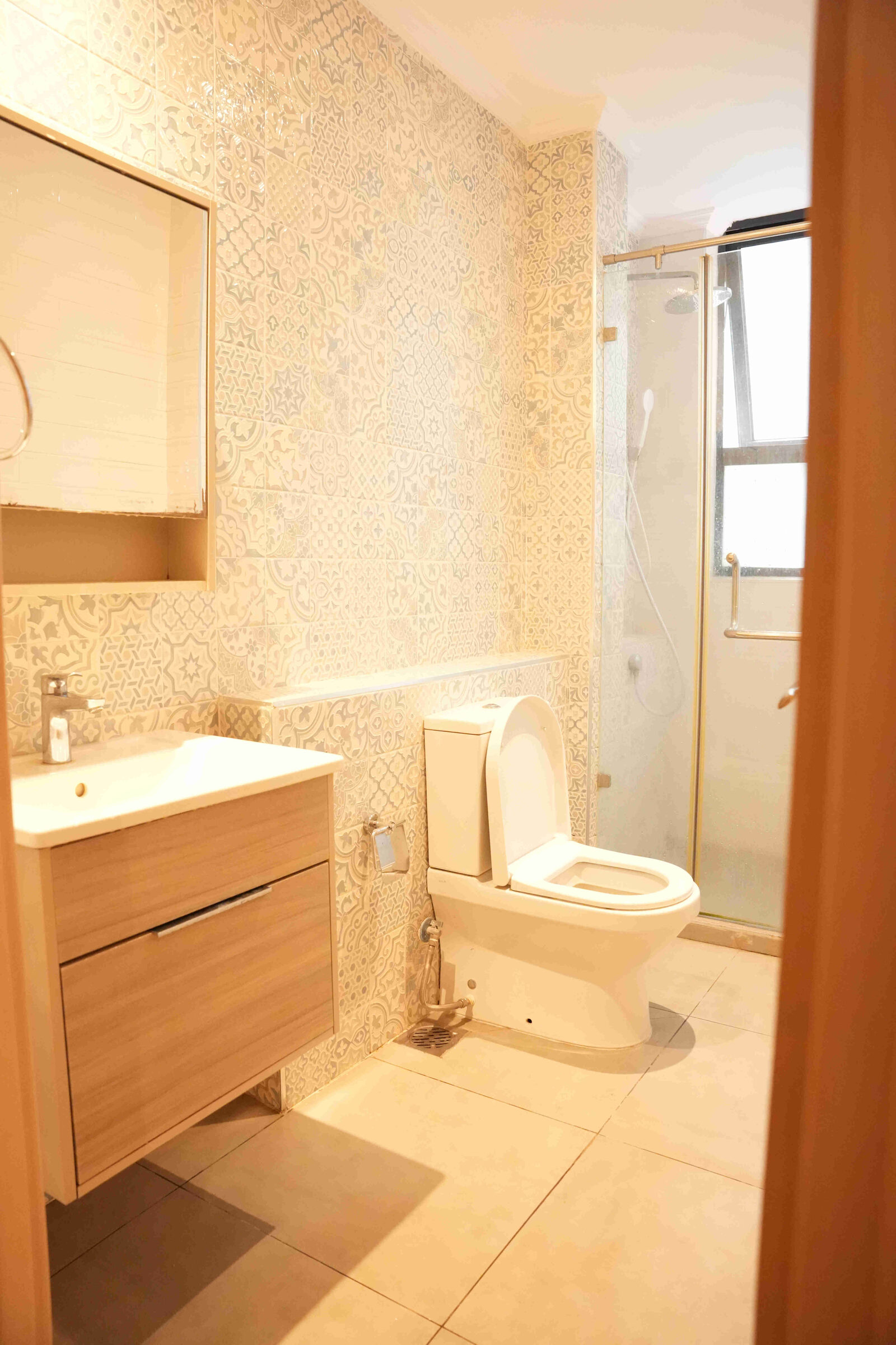 En-suite bathroom with patterned wall tiles, vanity, WC and glass shower at 5th Park Heights