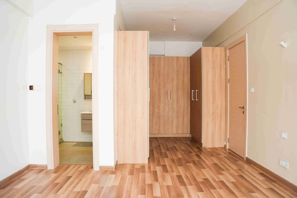 Bedroom with full-height built-in wardrobes and en-suite doorway at 5th Park Heights