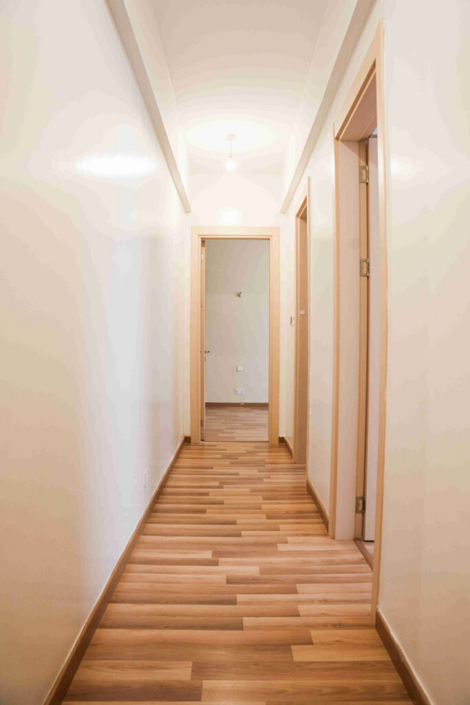 Internal corridor with timber flooring leading to bedrooms at 5th Park Heights