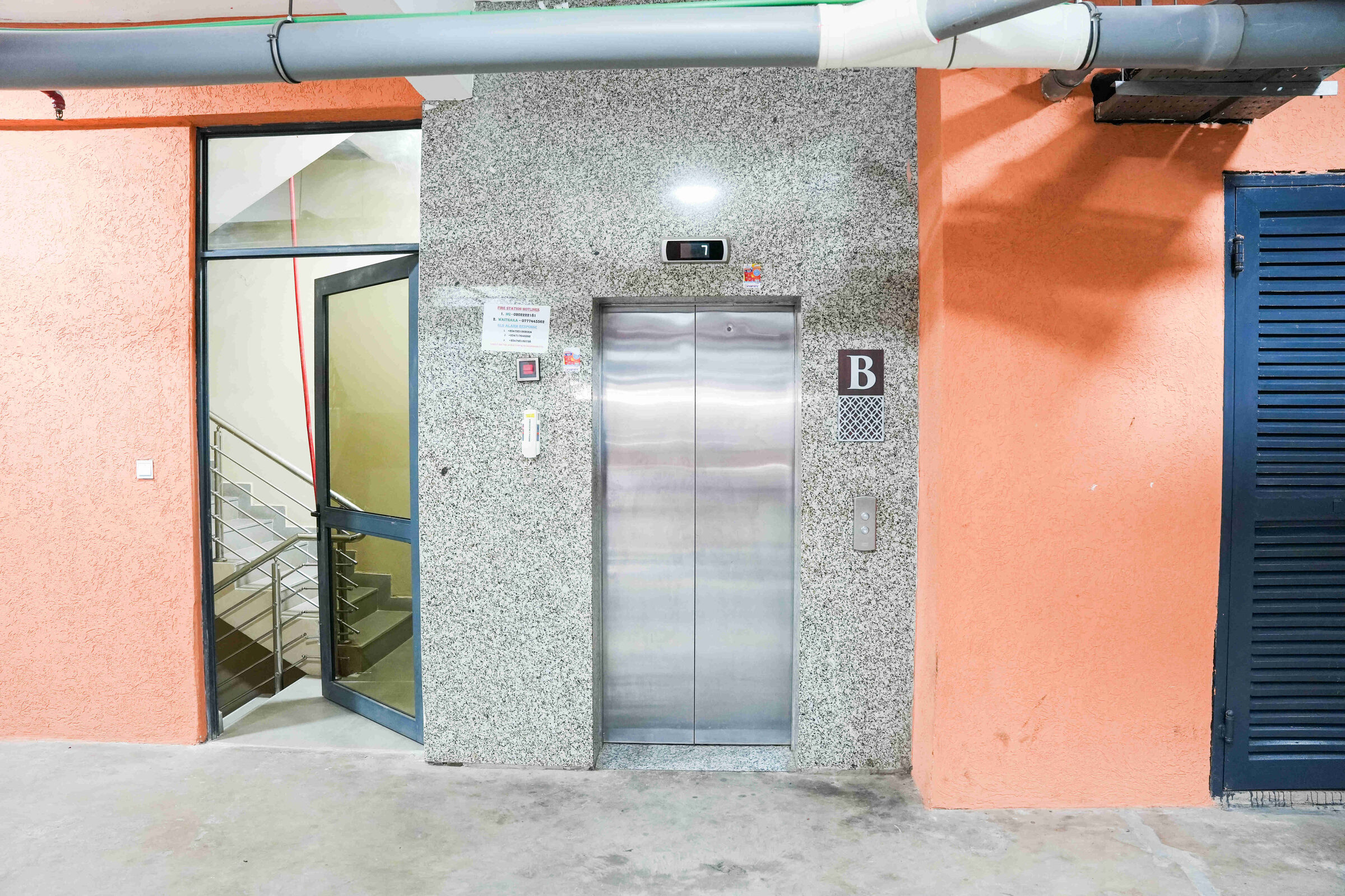 Lift lobby at basement level with steel elevator doors and staircase at 5th Park Heights