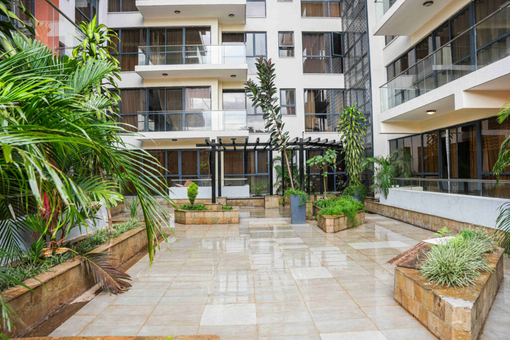 Paved courtyard with raised planters and pergola at 5th Park Heights