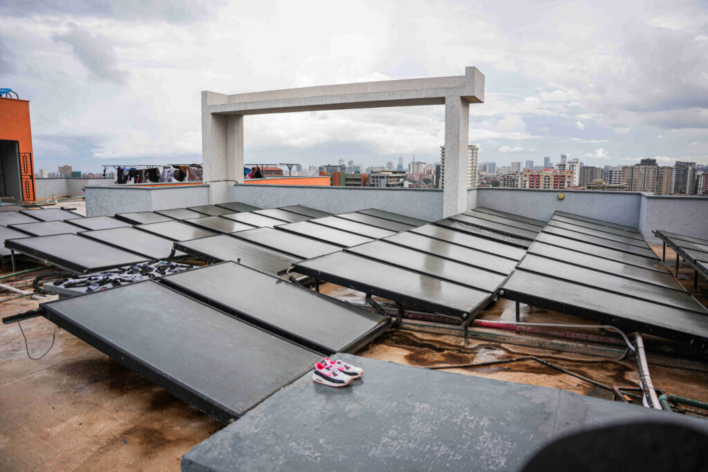 Rooftop solar water heating panels with Nairobi skyline at 5th Park Heights