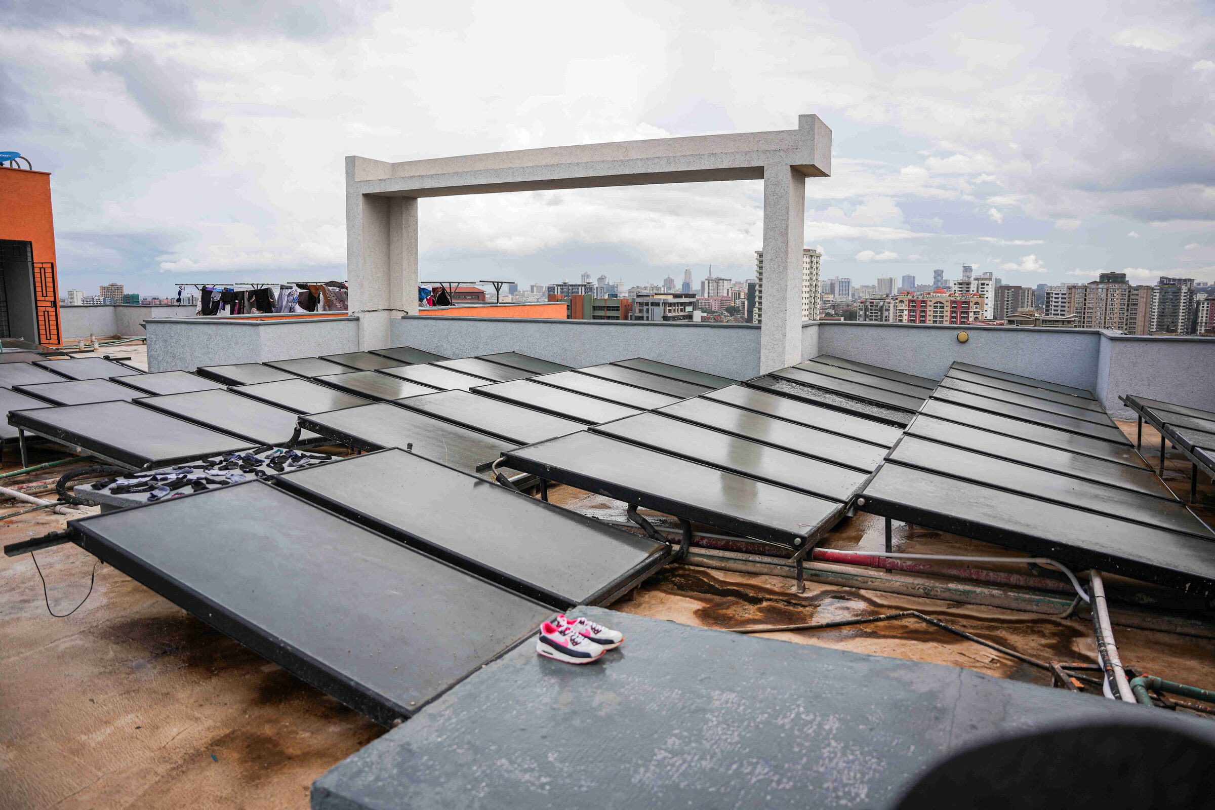 Rooftop solar water heating panels with Nairobi skyline at 5th Park Heights